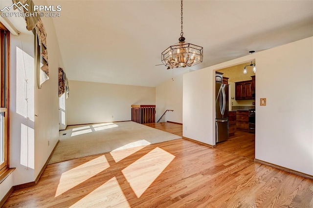 interior space with light hardwood / wood-style floors and a notable chandelier