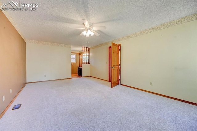 empty room featuring ceiling fan and a textured ceiling