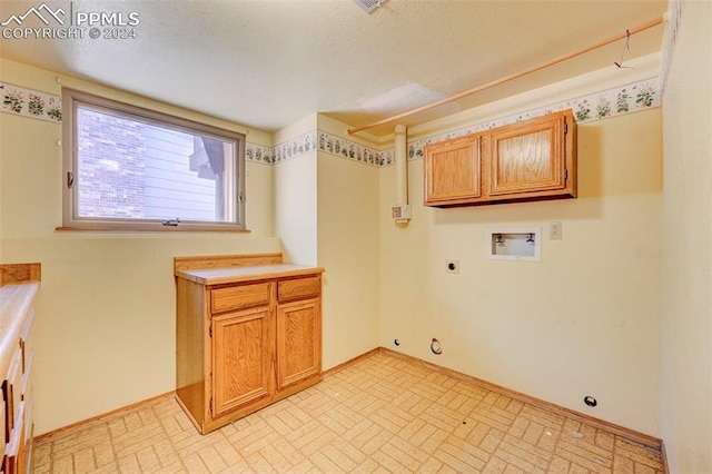 washroom featuring cabinets, hookup for a gas dryer, washer hookup, and electric dryer hookup