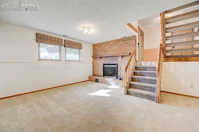 unfurnished living room featuring light carpet, a textured ceiling, and a fireplace