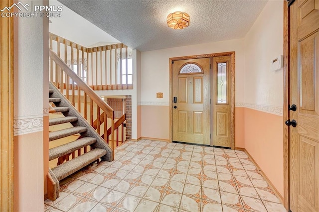 entrance foyer with a textured ceiling