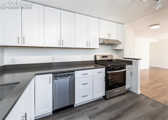 kitchen featuring dark wood-type flooring, white cabinets, and stainless steel appliances