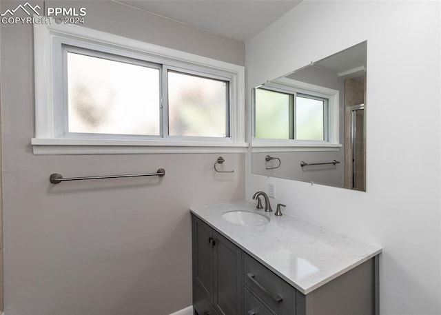 bathroom featuring vanity and an enclosed shower