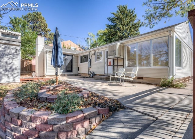 back of property with a patio