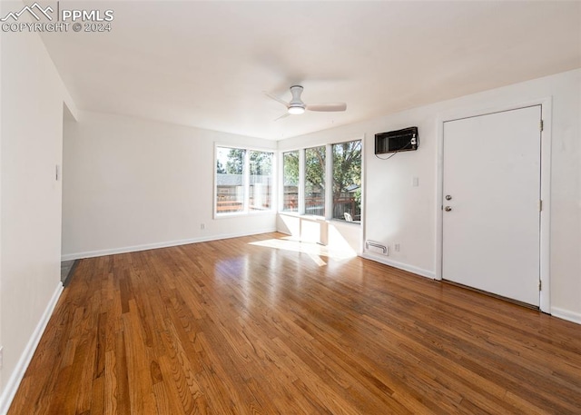 empty room with ceiling fan and hardwood / wood-style floors