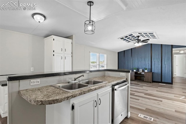 kitchen featuring white cabinets, dishwasher, sink, and vaulted ceiling