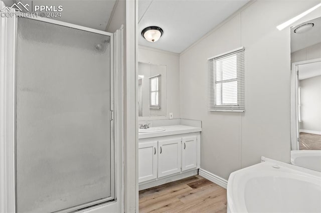 bathroom with lofted ceiling, hardwood / wood-style flooring, crown molding, vanity, and an enclosed shower