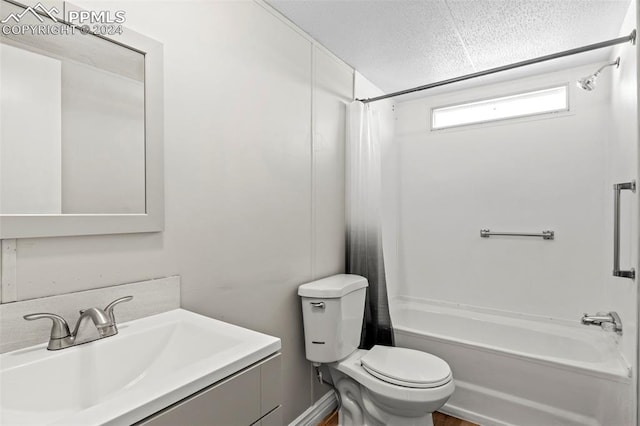 full bathroom featuring vanity, toilet, shower / bath combination with curtain, and a textured ceiling