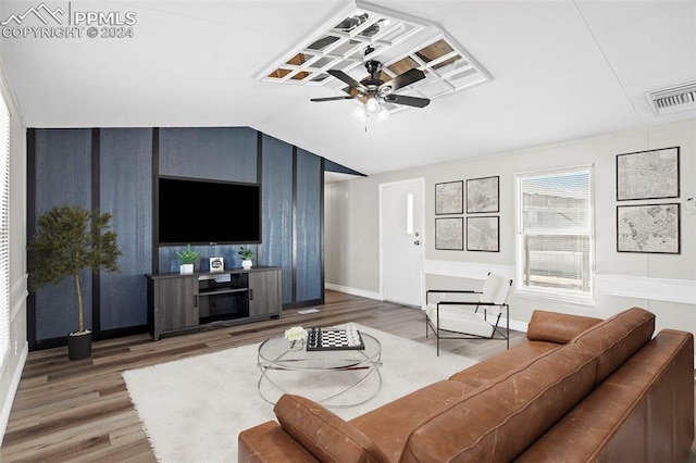 living room with dark wood-type flooring, ceiling fan, and vaulted ceiling