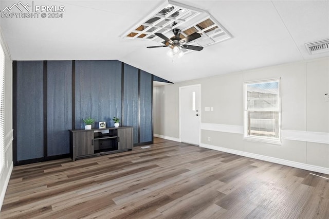 unfurnished living room featuring ceiling fan, vaulted ceiling, and dark hardwood / wood-style flooring