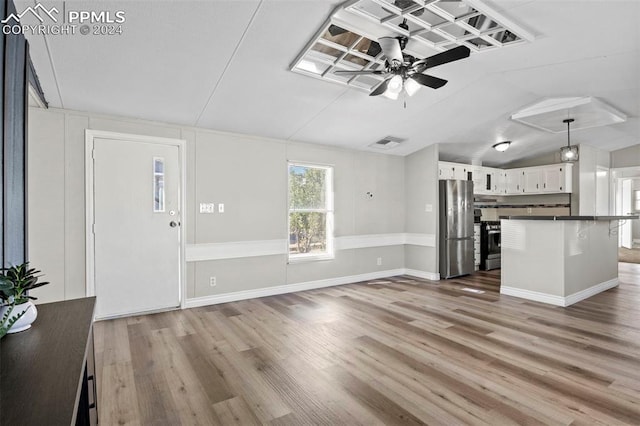 unfurnished living room with lofted ceiling, wood-type flooring, and ceiling fan