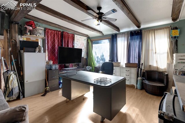 office area featuring beamed ceiling, light hardwood / wood-style floors, and ceiling fan