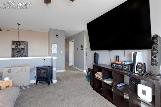 carpeted living room with a wood stove