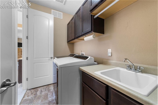 laundry room with cabinets, washer / clothes dryer, and sink