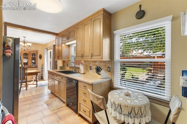 kitchen featuring stainless steel refrigerator, sink, an inviting chandelier, black dishwasher, and backsplash