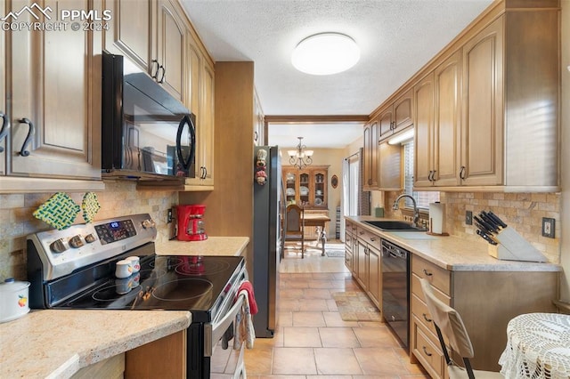 kitchen featuring backsplash, sink, black appliances, a notable chandelier, and light tile patterned flooring