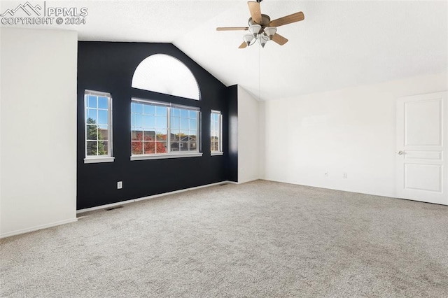 carpeted empty room with ceiling fan and vaulted ceiling