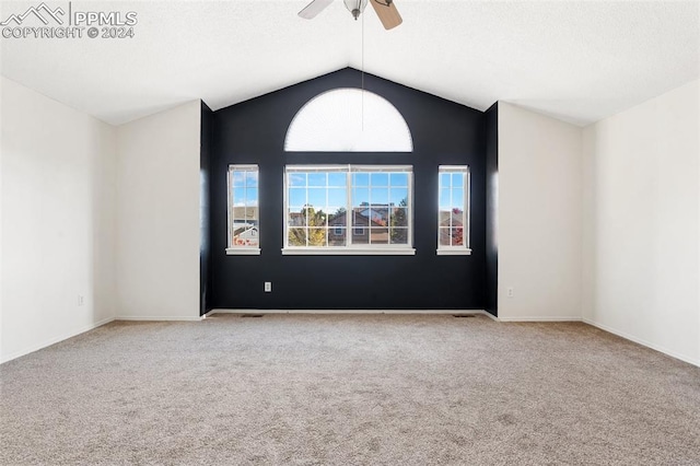 empty room with vaulted ceiling, light carpet, and ceiling fan