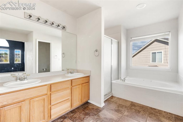 bathroom featuring vanity and a relaxing tiled tub