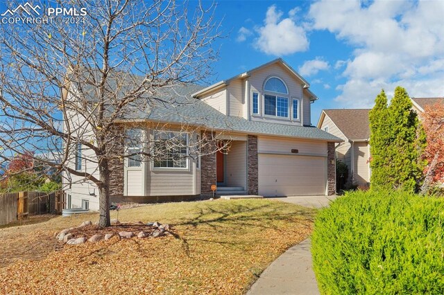 front of property with a front lawn and a garage