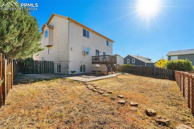 rear view of house featuring a deck and a patio area