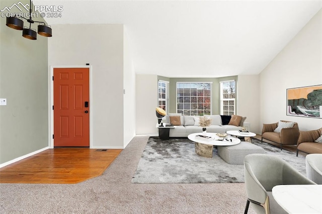 living room with lofted ceiling and hardwood / wood-style flooring