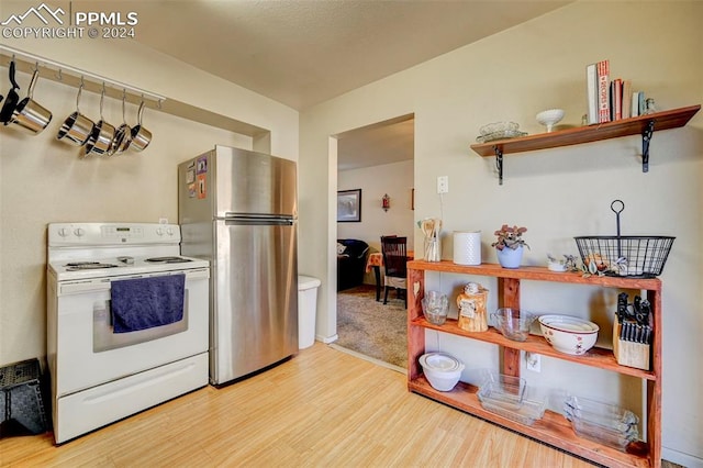 kitchen featuring light hardwood / wood-style floors, electric range, and stainless steel refrigerator