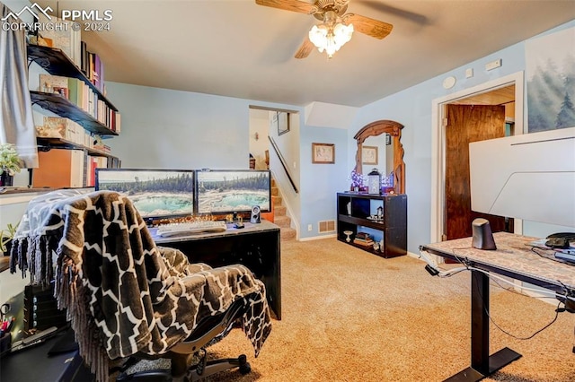 carpeted office space with ceiling fan