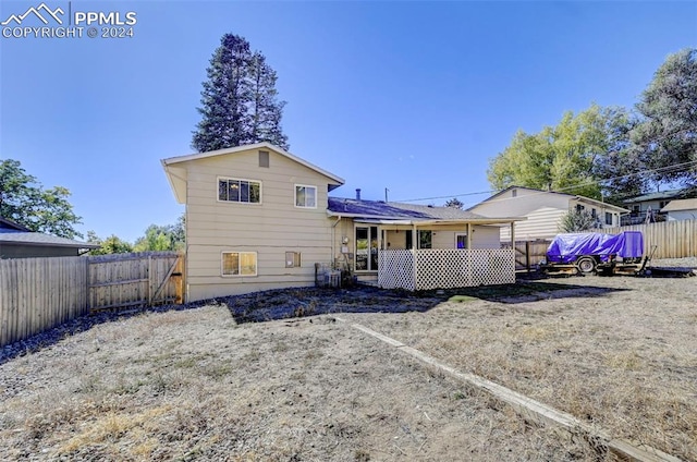 rear view of property with a wooden deck