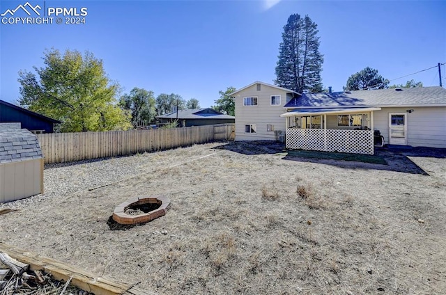 view of yard with an outdoor fire pit