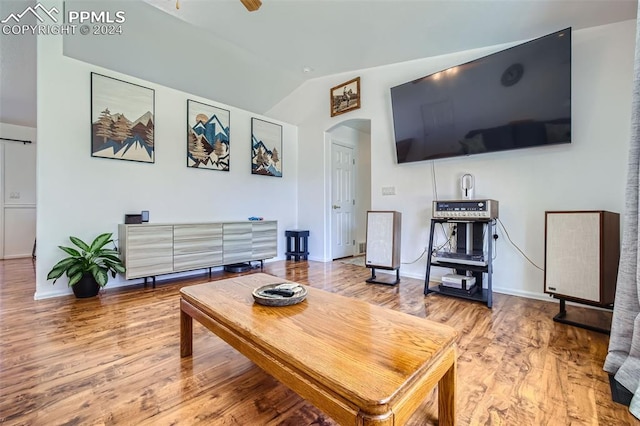 living room featuring vaulted ceiling, wood-type flooring, and ceiling fan