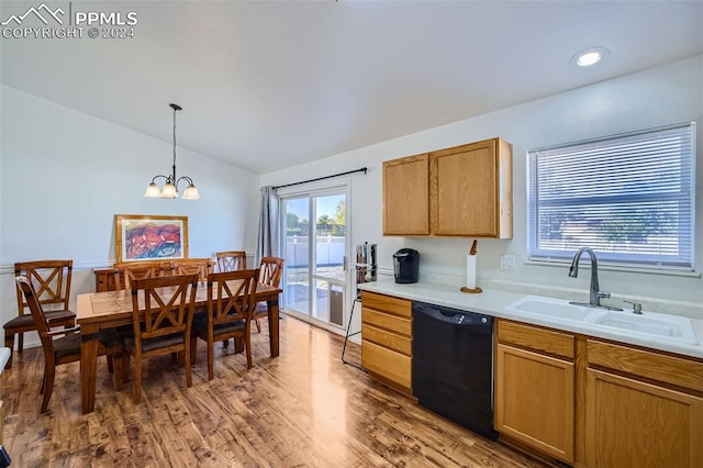 kitchen with lofted ceiling, dishwasher, dark wood-type flooring, pendant lighting, and sink