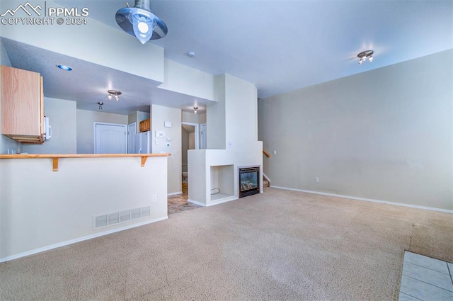 unfurnished living room featuring light carpet