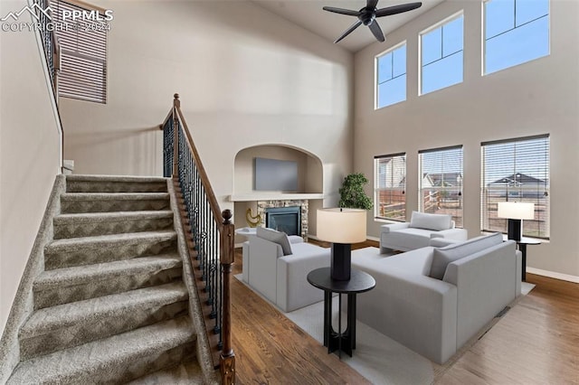 living room featuring wood-type flooring and a high ceiling