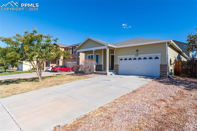 ranch-style house with a garage, a front yard, and a porch