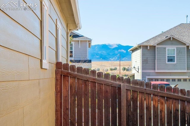 view of side of property with a garage and a mountain view