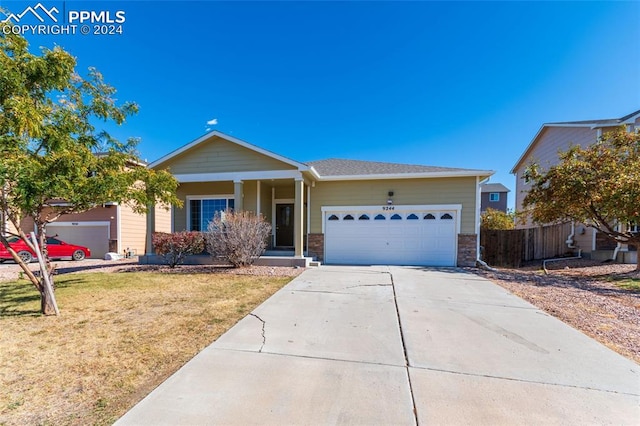 ranch-style house featuring a garage and a front lawn