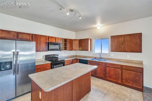 kitchen featuring black appliances, a kitchen island, and sink