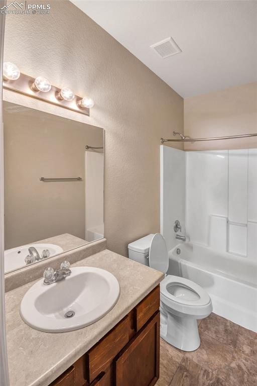 full bathroom with vanity, toilet, and bathtub / shower combination