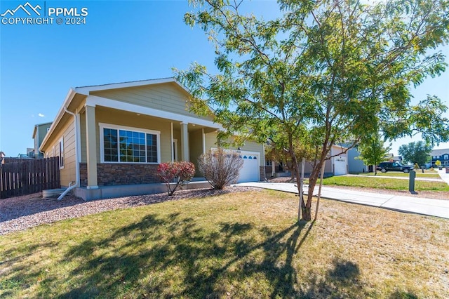 ranch-style home featuring a garage and a front lawn