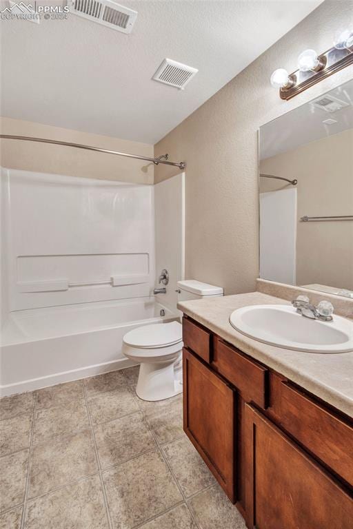 full bathroom with tub / shower combination, vanity, and toilet