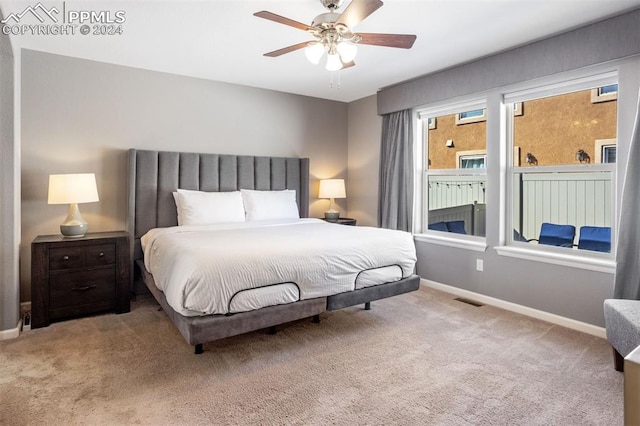 bedroom featuring ceiling fan and light carpet