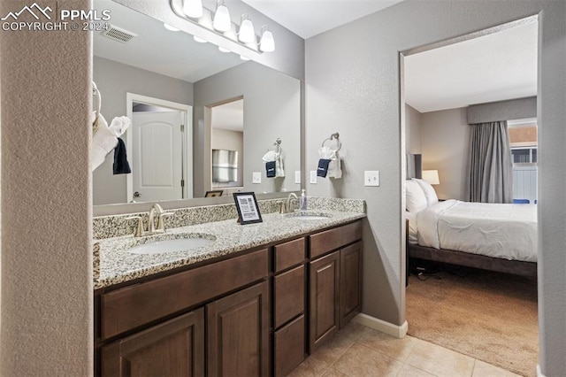 bathroom with tile patterned flooring and vanity