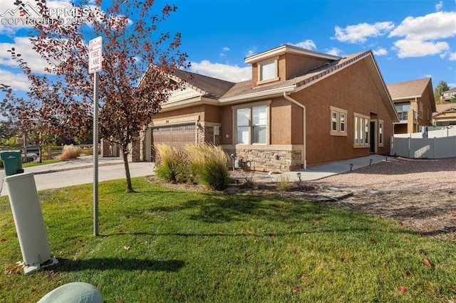 view of front facade with a front yard and a garage