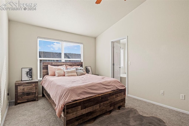 carpeted bedroom featuring ensuite bath, ceiling fan, and vaulted ceiling