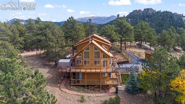 back of house featuring a deck with mountain view