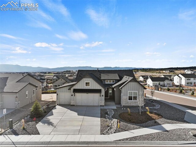 view of front facade with a garage and a mountain view