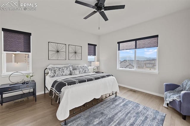 bedroom with light hardwood / wood-style flooring and ceiling fan