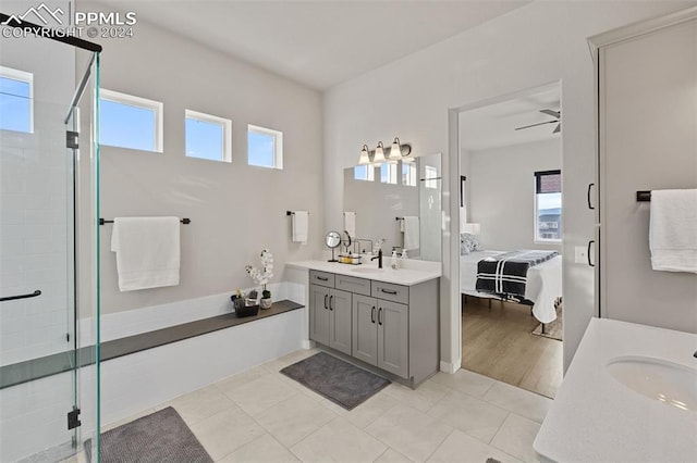 bathroom featuring vanity, ceiling fan, plenty of natural light, and an enclosed shower