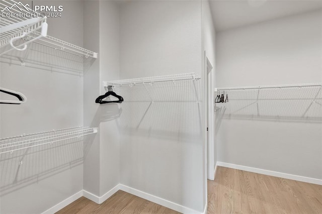 spacious closet featuring hardwood / wood-style flooring